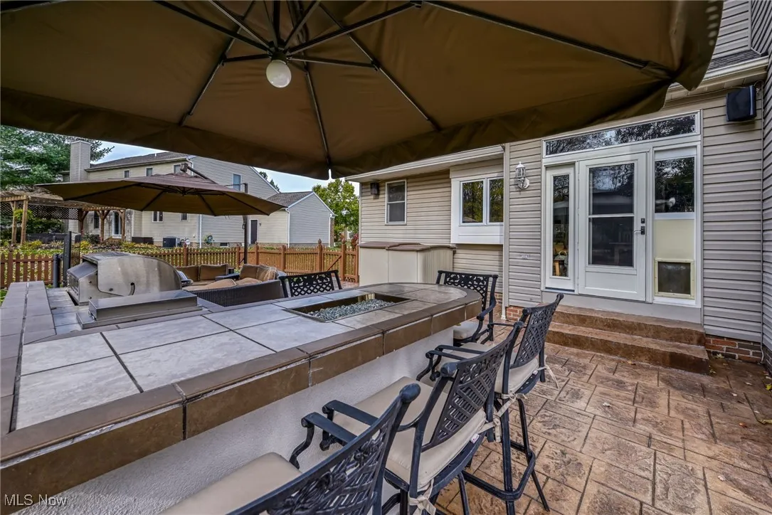 View of patio / terrace featuring a gazebo, exterior kitchen, and entry steps