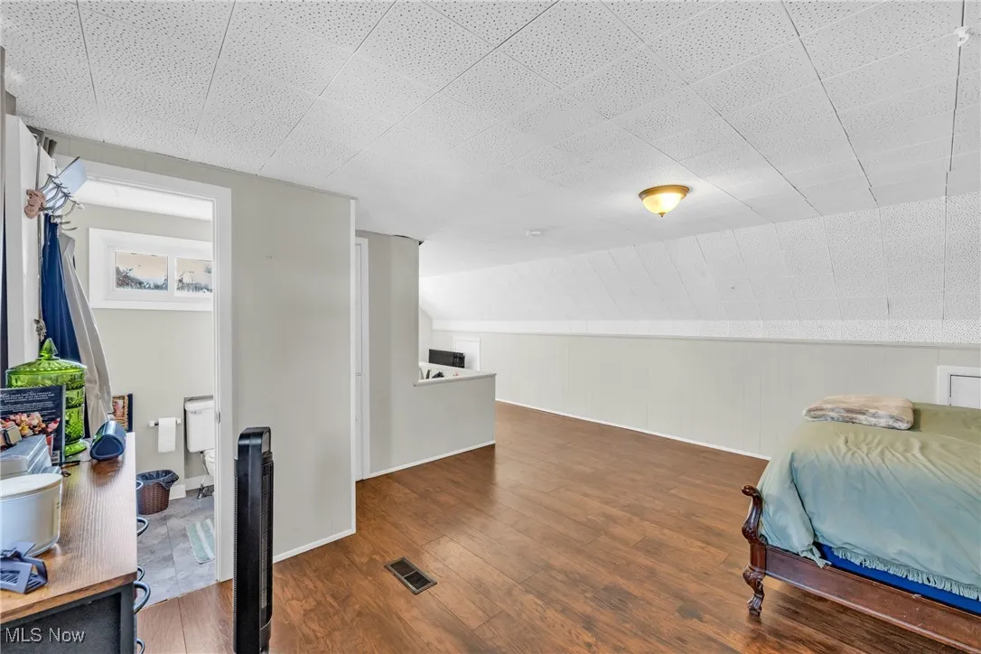 Bedroom featuring dark wood-type flooring