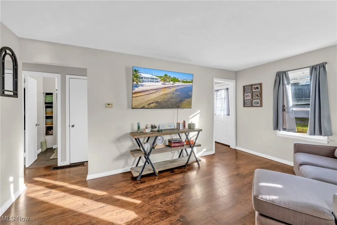Living area featuring hardwood / wood-style flooring and baseboards
