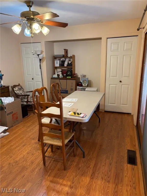 Dining room featuring light wood-type flooring and a ceiling fan