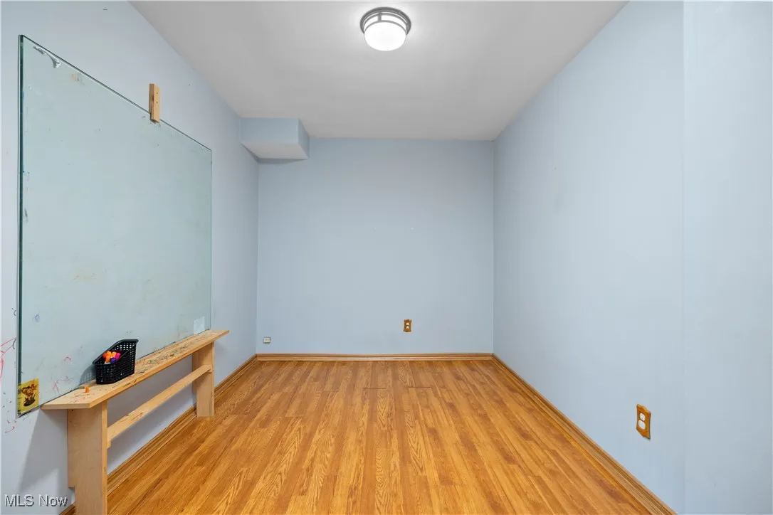 Bonus room on first floor featuring light wood-type flooring and baseboards