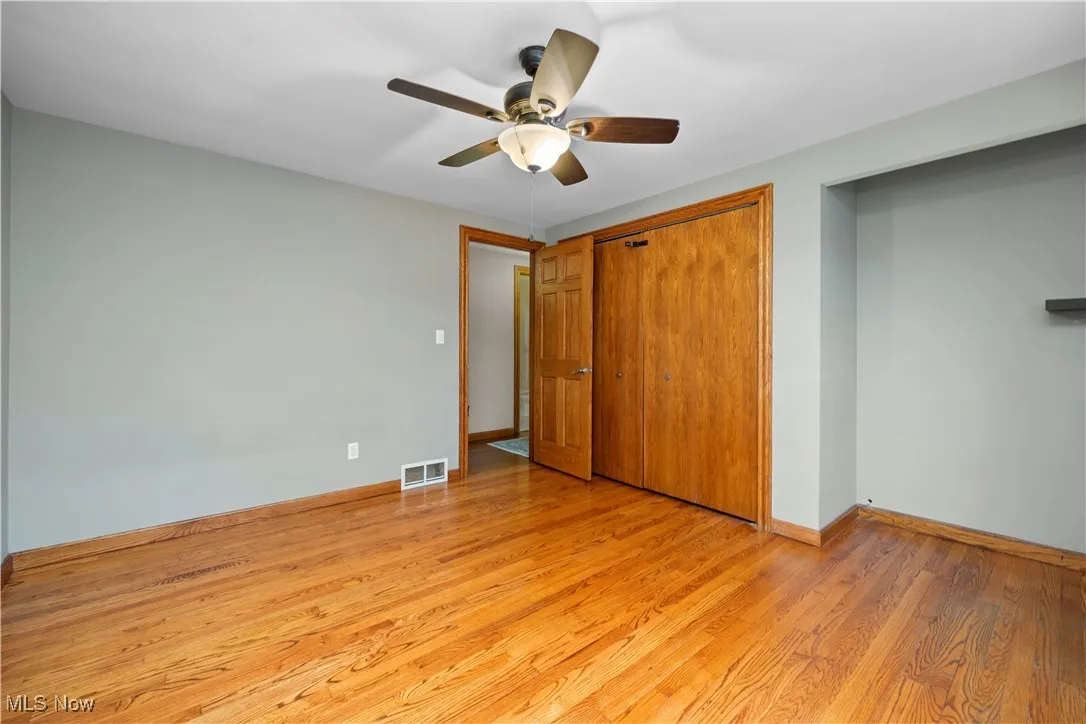 2rd bedroom with light wood-style flooring, a ceiling fan, and a closet