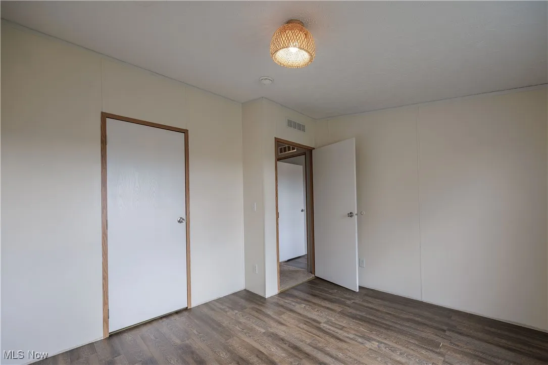 Unfurnished bedroom featuring wood finished floors