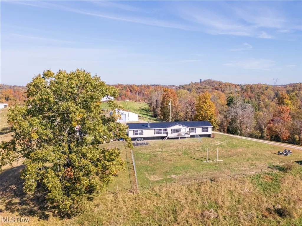 View of subject property with a heavily wooded area