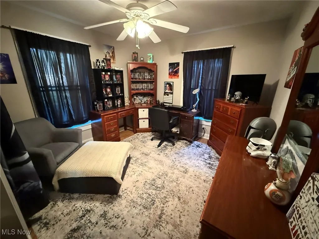 Office area with ceiling fan and wood finished floors