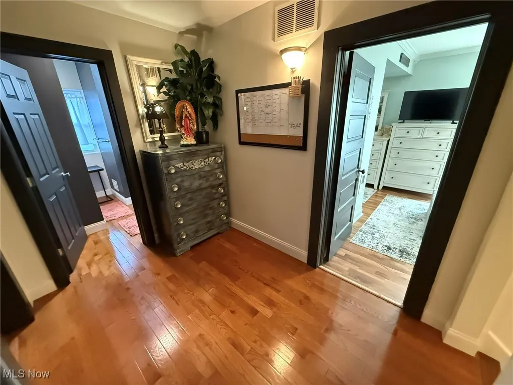 Bedroom featuring light wood-style floors and ensuite bathroom