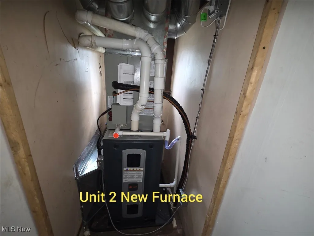 Utility room featuring heating unit