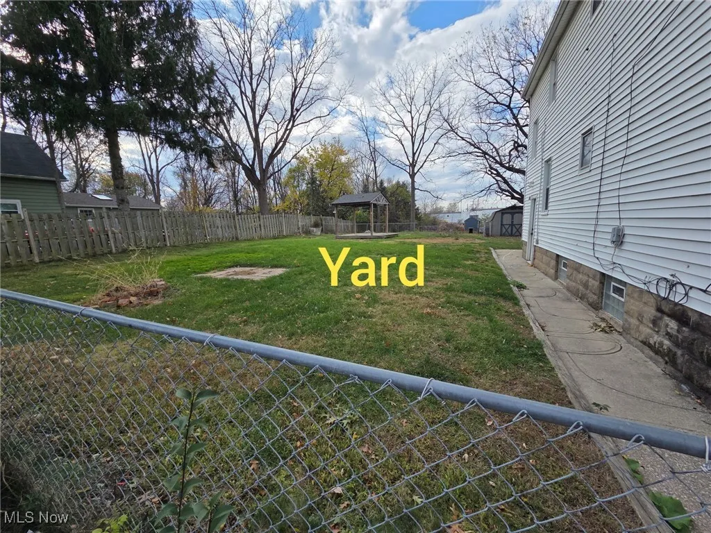 Fenced backyard with a gazebo
