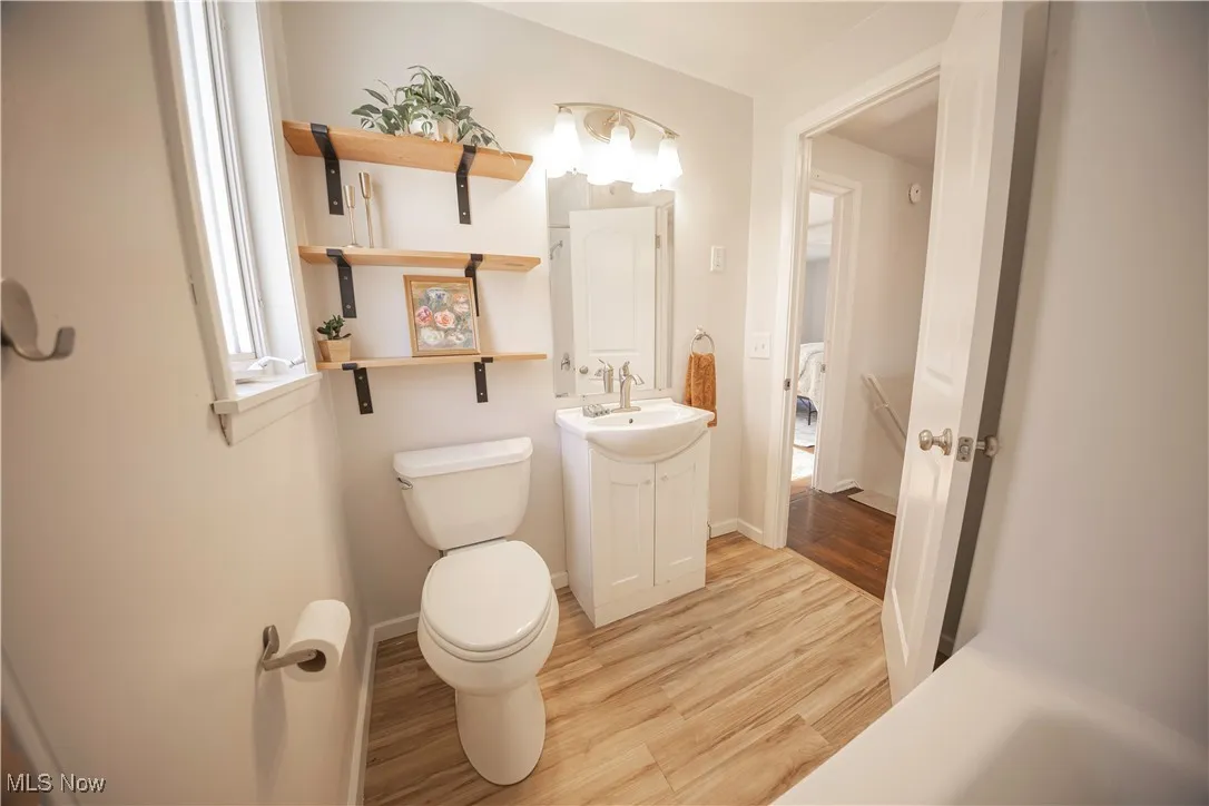 Half bath featuring light wood-style floors and vanity