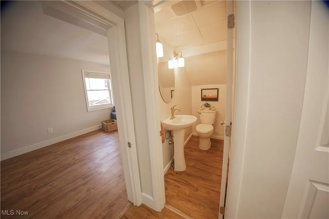 Half bathroom with light wood-style floors