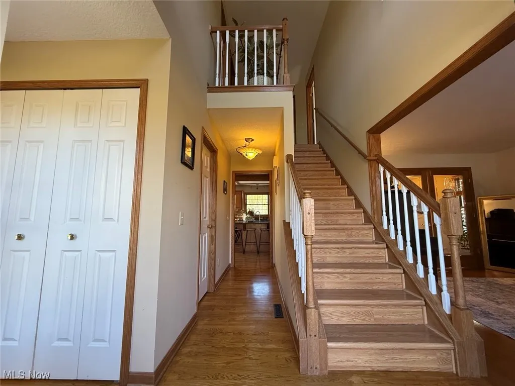 Staircase featuring wood finished floors and baseboards