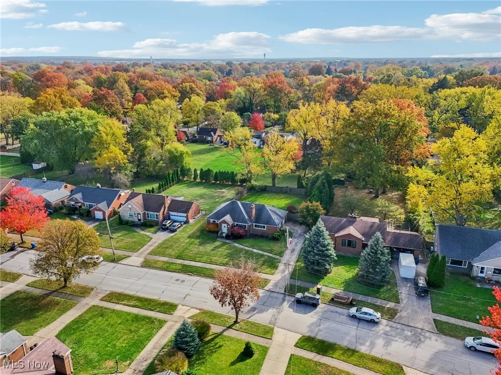 Aerial view of residential area with a heavily wooded area