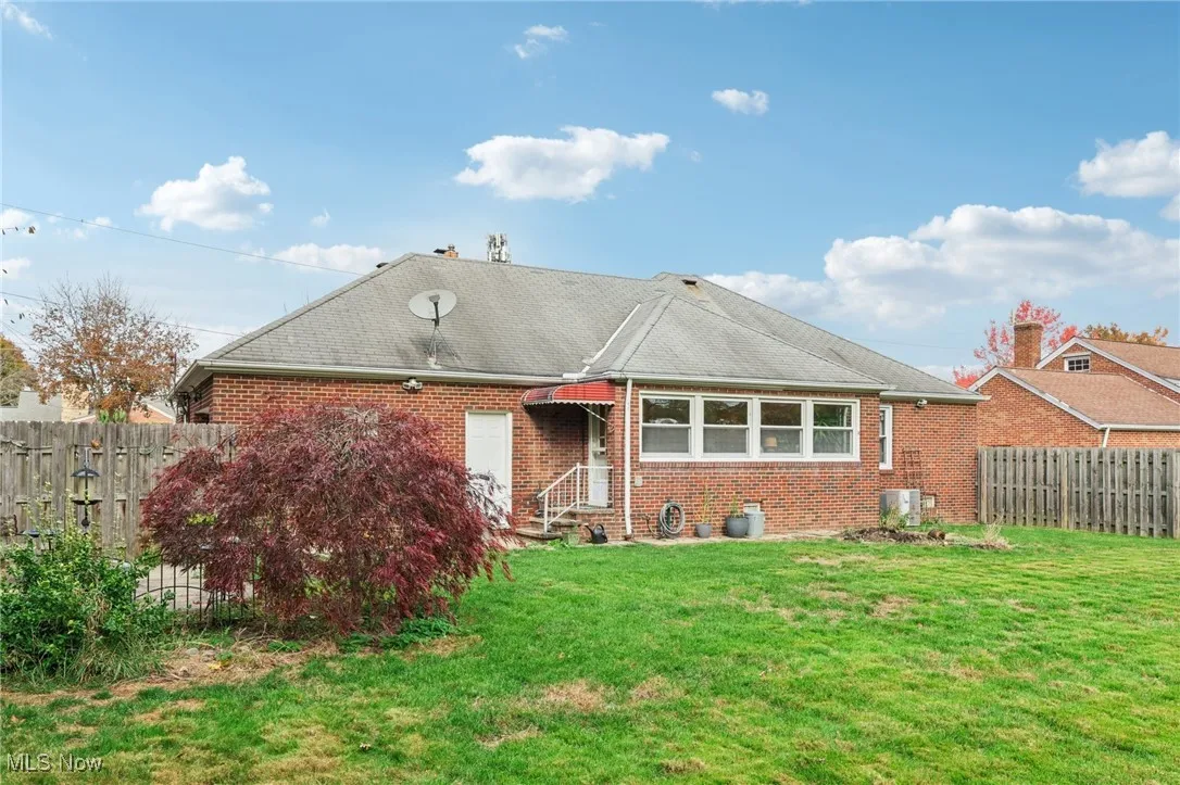 Single story home with brick siding and a shingled roof