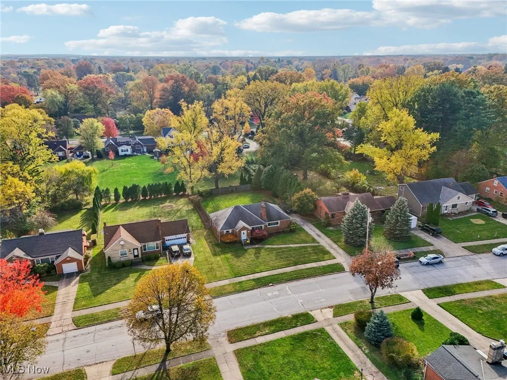 Aerial perspective of suburban area with a heavily wooded area