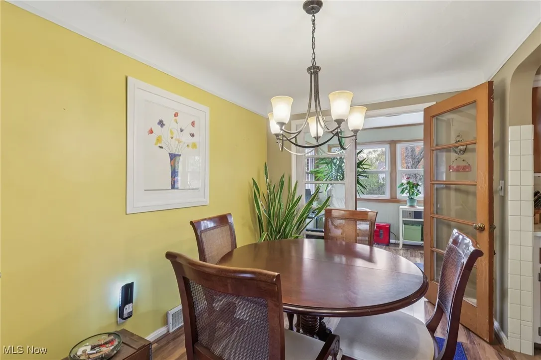 Dining room with a chandelier and wood finished floors