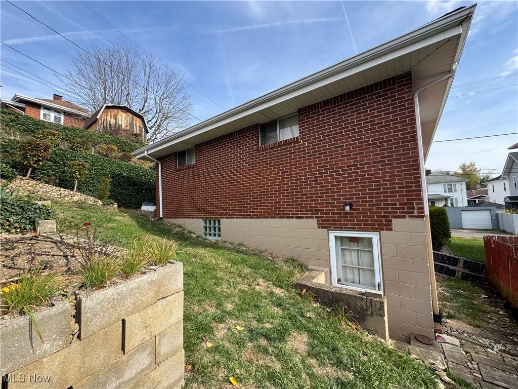 View of side of property featuring brick siding