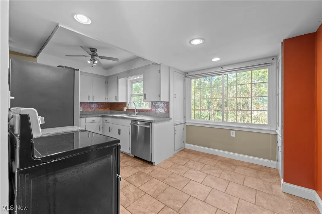 Kitchen with stainless steel appliances, recessed lighting, tasteful backsplash, a ceiling fan, and light tile patterned flooring