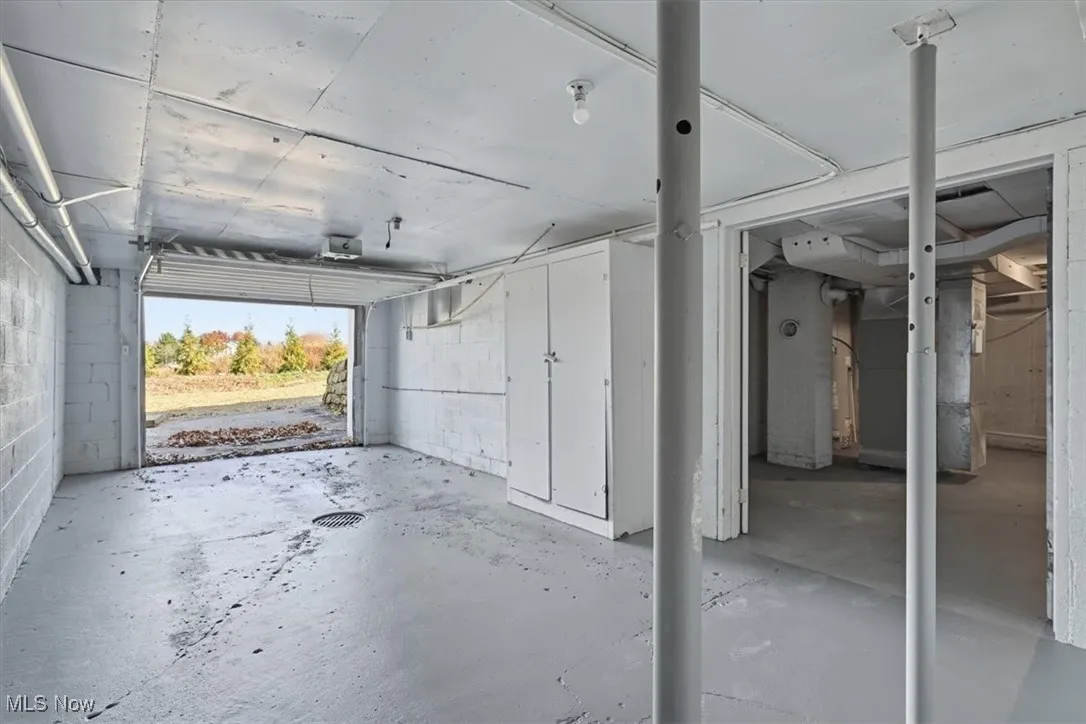 Lower level/ parking area, lawn equipment.