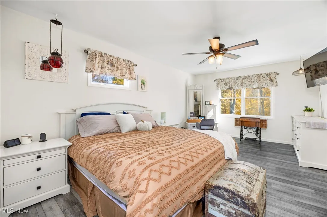 Bedroom featuring dark wood-style flooring and a ceiling fan