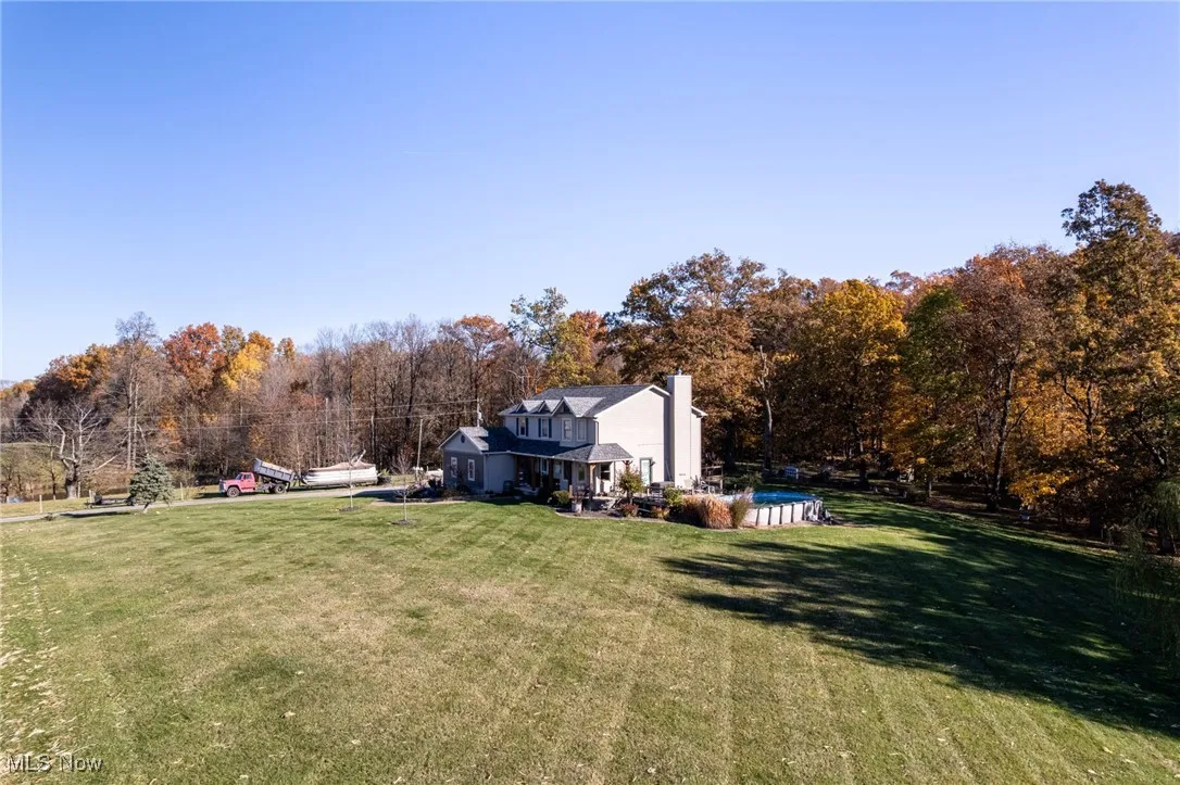 View of grassy yard featuring an outdoor pool
