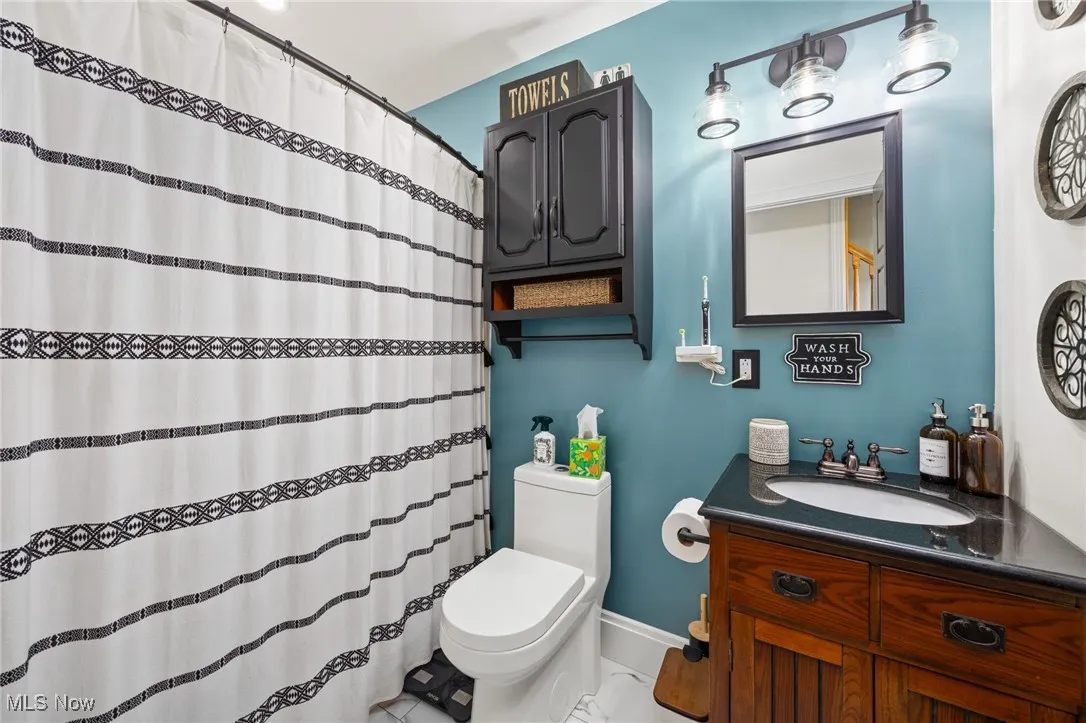 Full bath featuring vanity and a shower with curtain