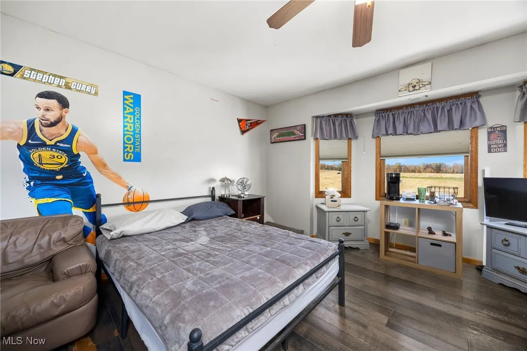 Bedroom featuring dark wood-style floors and a ceiling fan