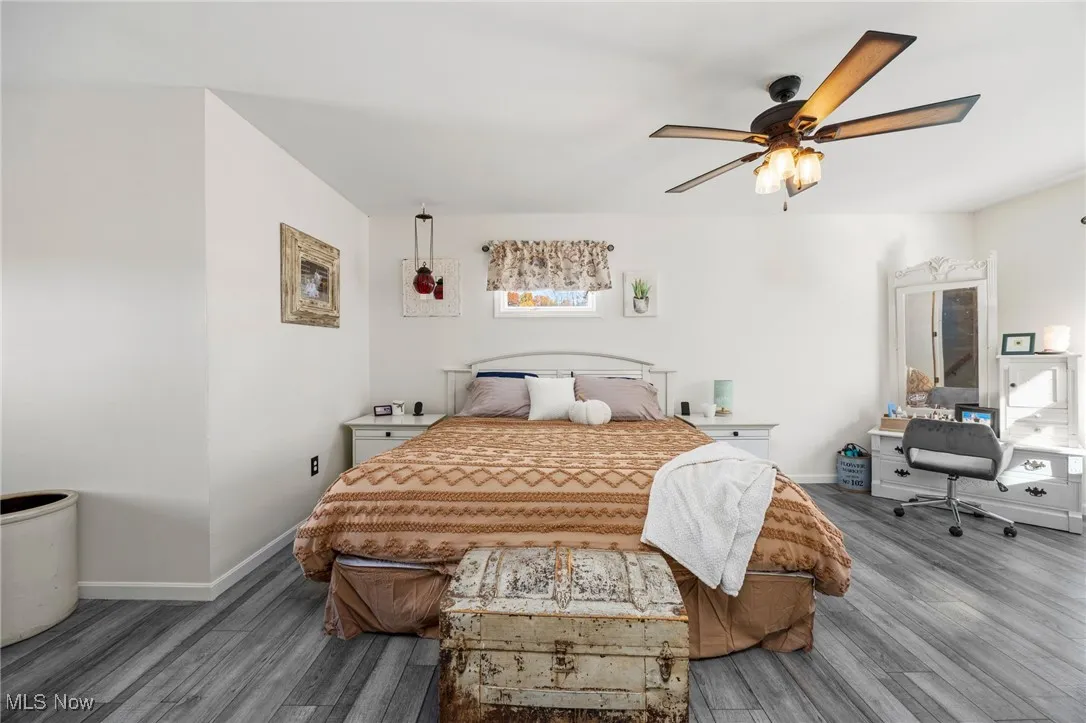 Bedroom featuring wood finished floors and a ceiling fan