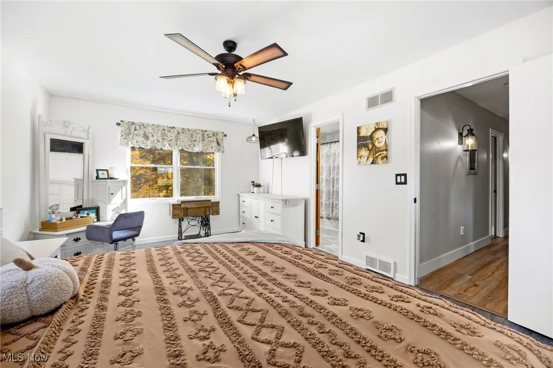 Bedroom with ceiling fan and wood finished floors