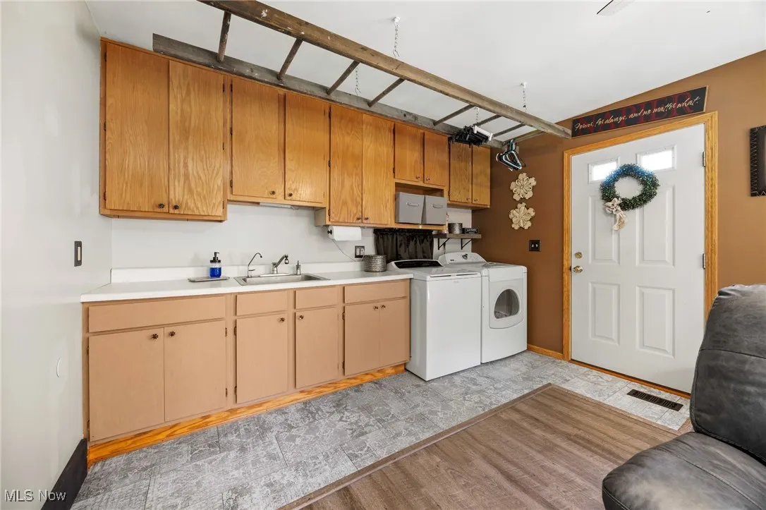 Laundry room featuring cabinet space and washing machine and clothes dryer