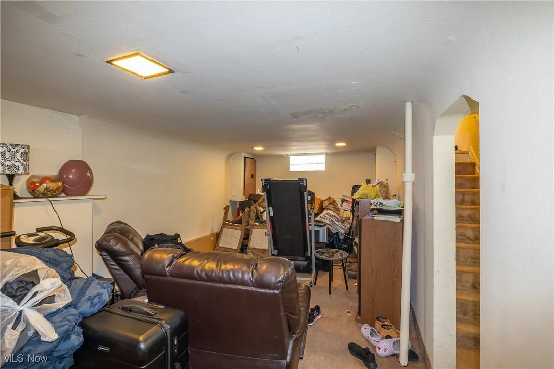 Living area with carpet and stairs