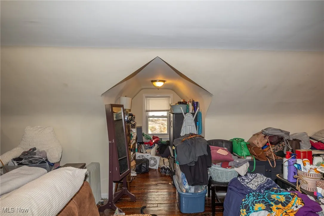 Bonus room featuring hardwood / wood-style flooring and radiator heating unit