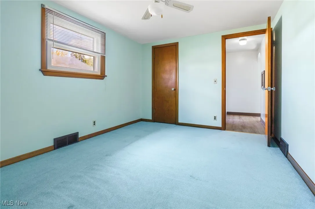 Unfurnished bedroom featuring carpet floors, a ceiling fan, and a closet