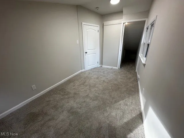 Unfurnished bedroom featuring carpet flooring and baseboards