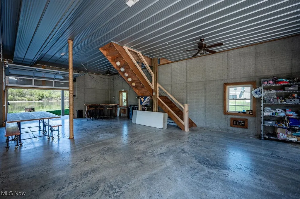 Lower level garage area with custom oversize garage doors, high ceilings poured concrete walls-wonderful for entertaining and nice storage.