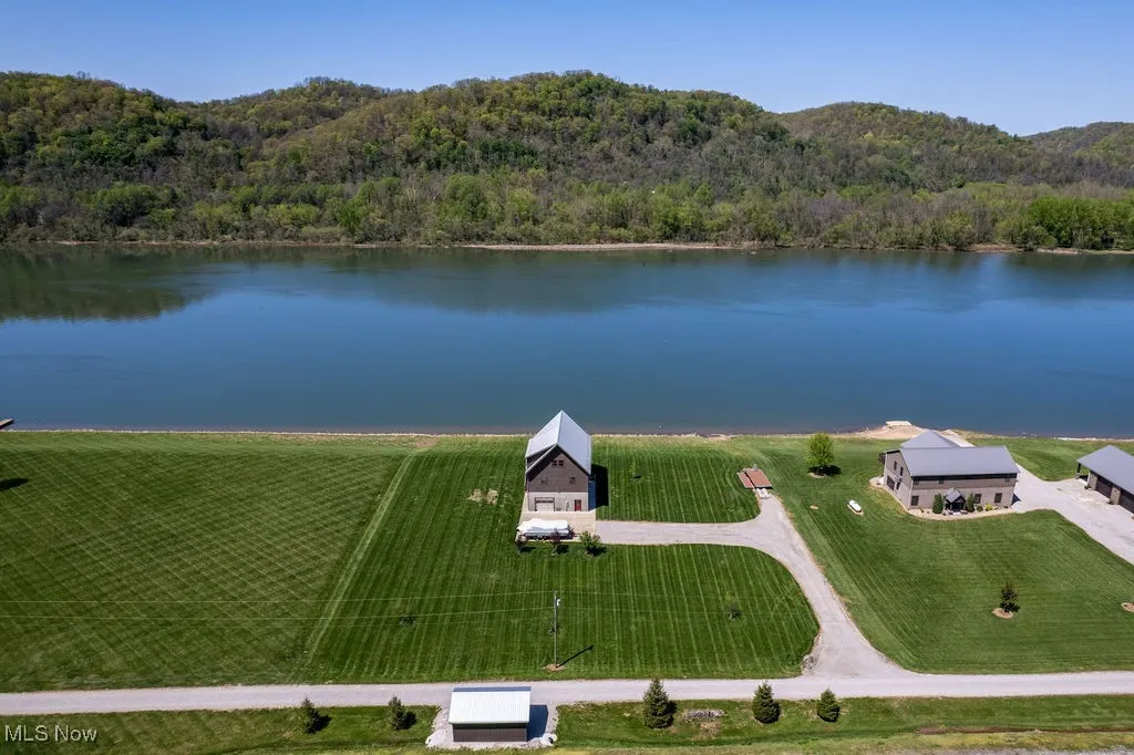 Aerial view showing new concrete storage building built in 2024 and view across river.