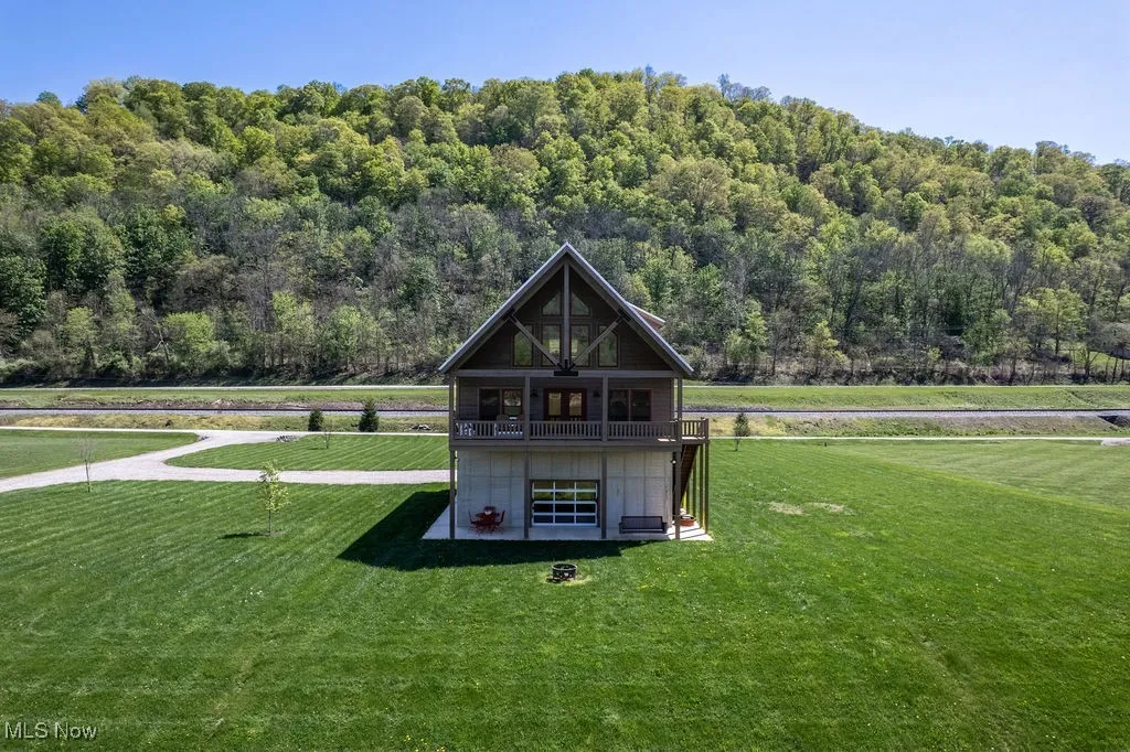 Aerial view river side   of home showing 2.13 ac lot w/large windows and depth of land