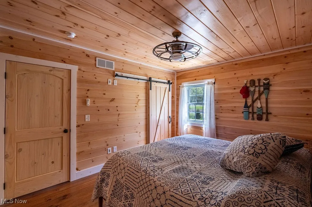 Bedroom #1 showing barn door on walk in closet.