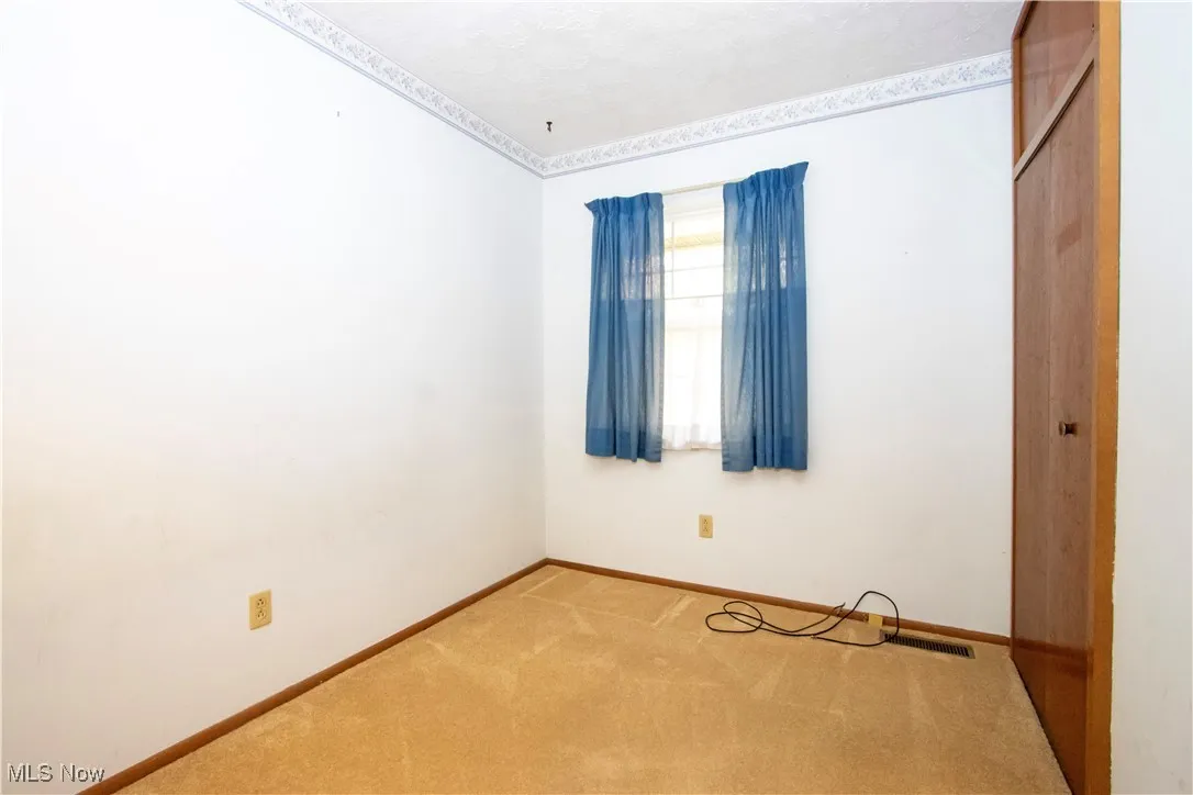 Spare room with carpet floors and baseboards