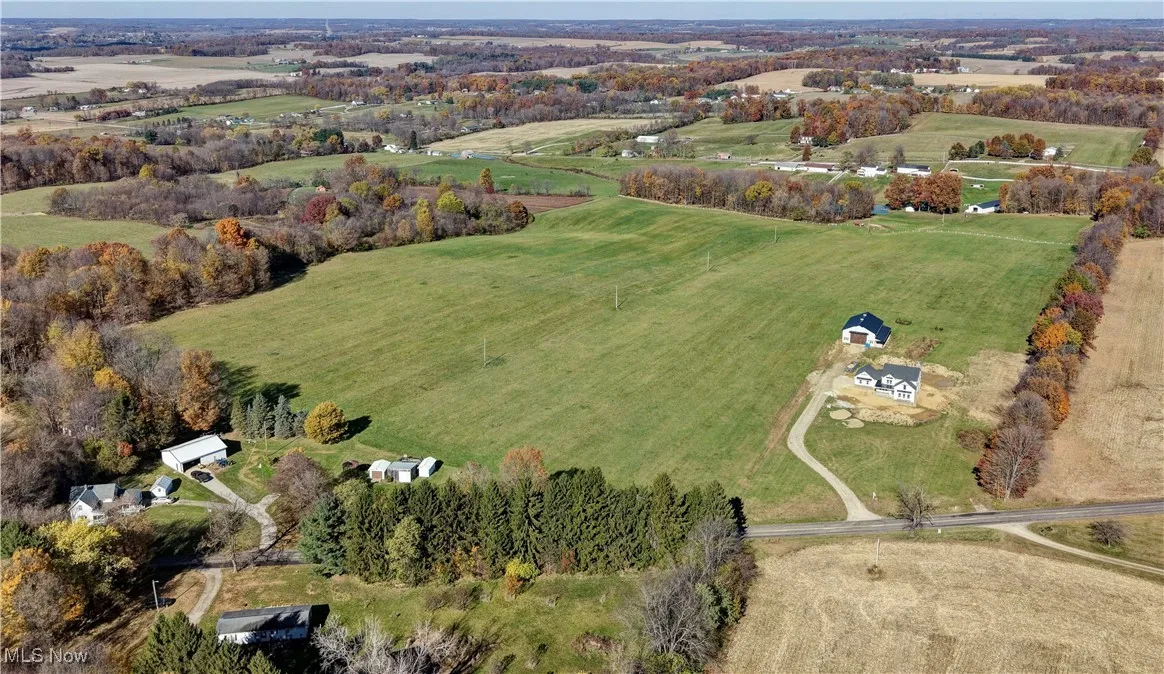 Aerial view of property and surrounding area with rural landscape