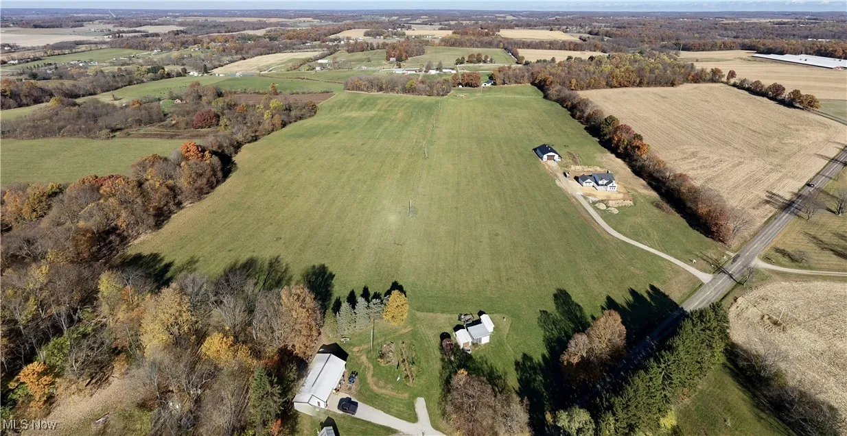 Aerial view of property and surrounding area featuring rural landscape