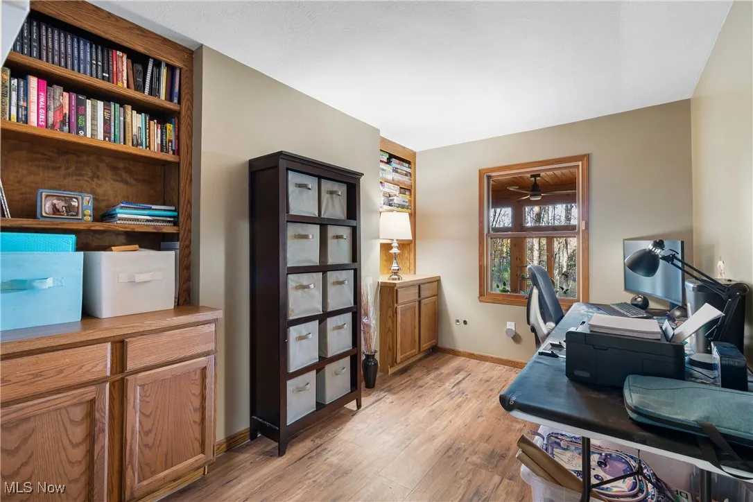 Office space featuring light wood finished floors and baseboards