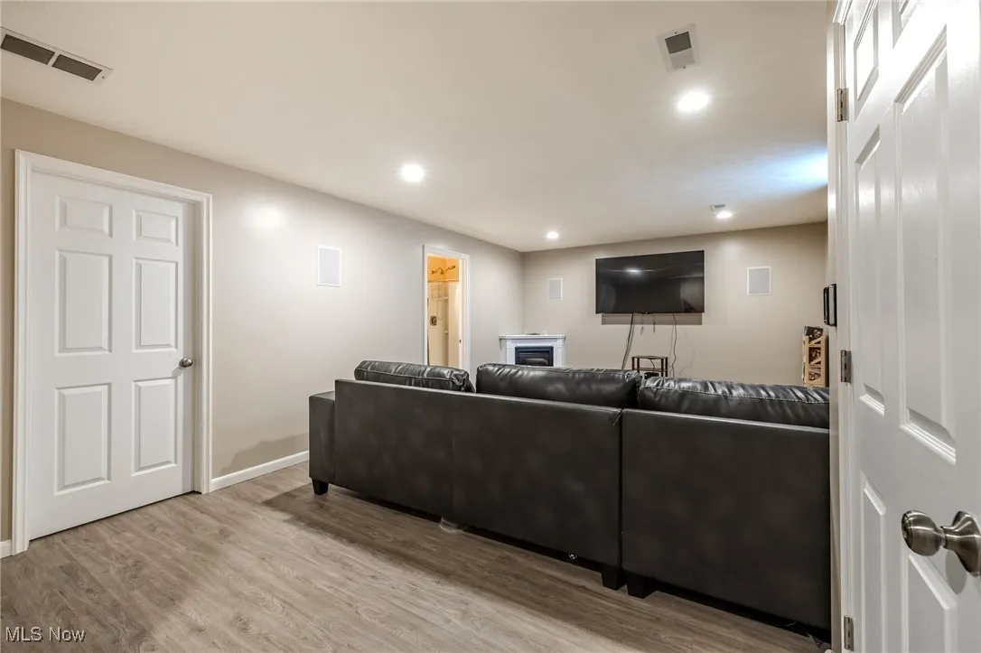 Living area featuring light wood-style flooring and recessed lighting