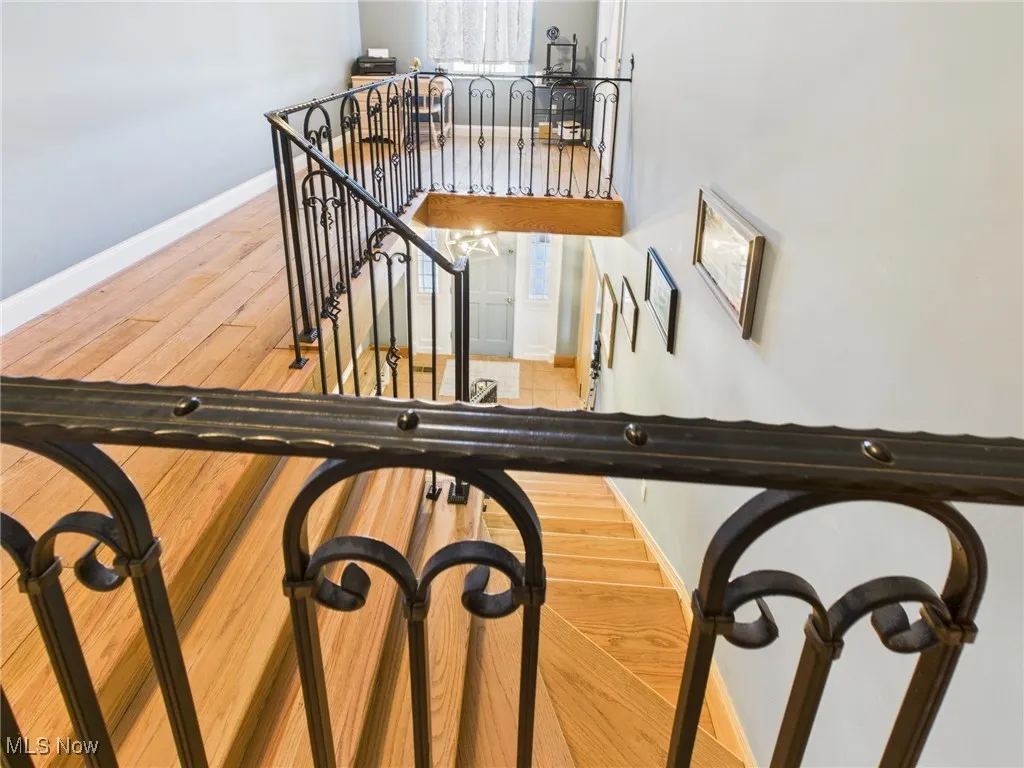 Stairs featuring wood finished floors and baseboards