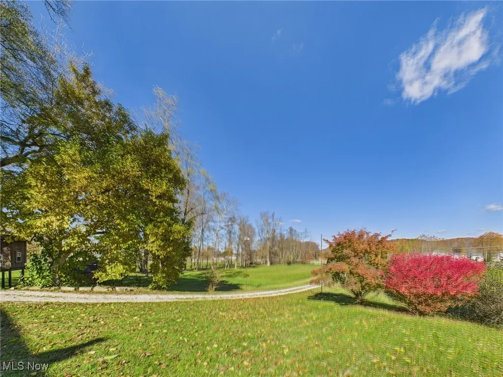 View of property's community with a lawn