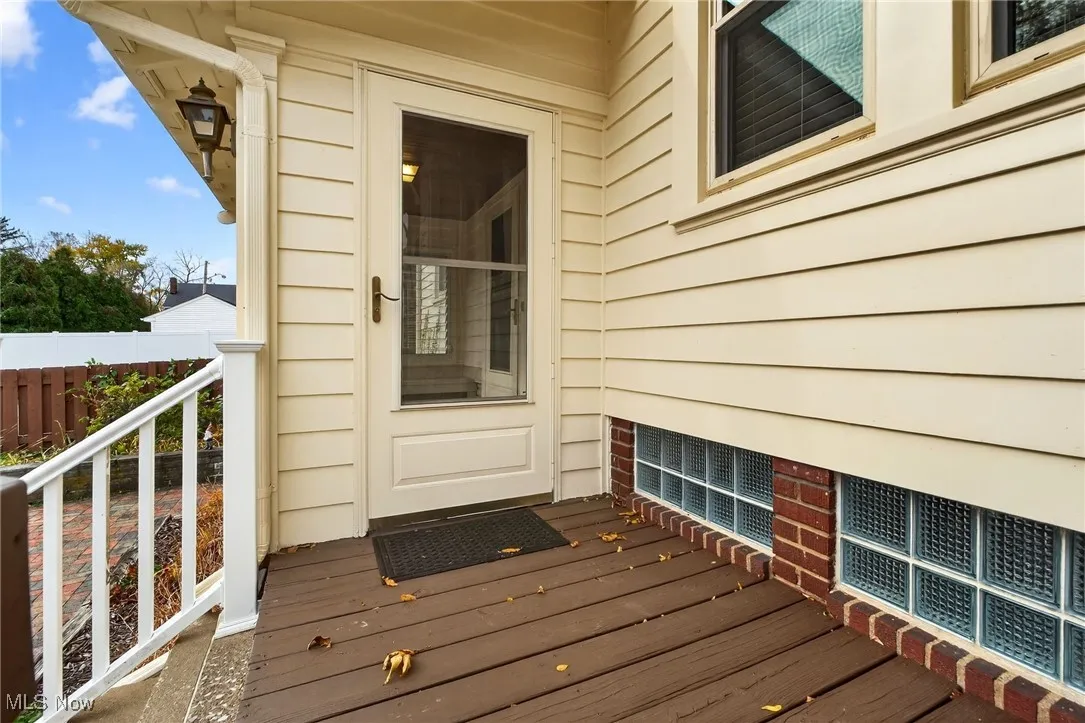 View of exterior entry with a wooden deck