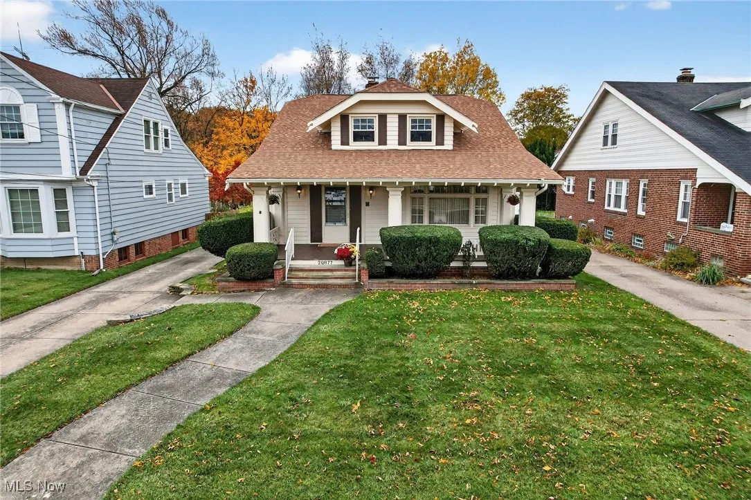 Bungalow-style house with a porch, a front lawn, and a shingled roof