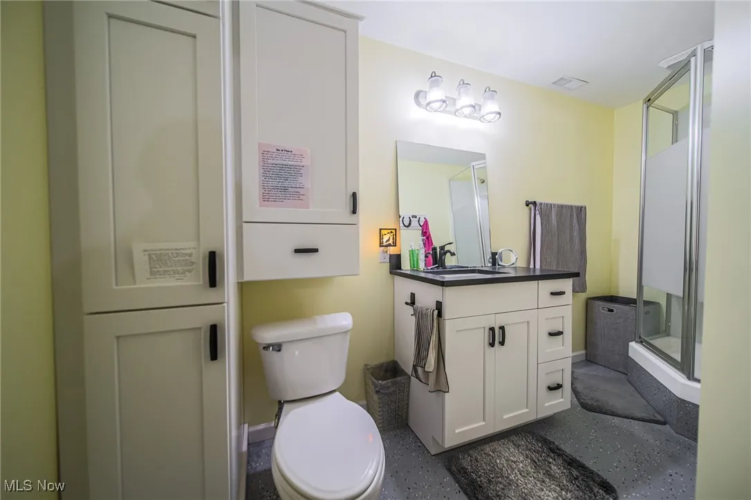 Full bath with vanity and a stall shower