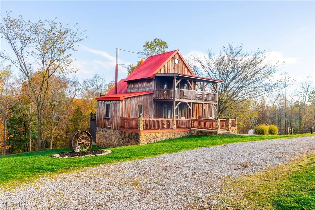 View of front of home with a front yard and a metal roof