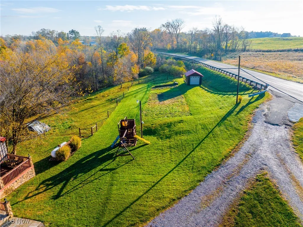 Surrounding community featuring a view of countryside and a deck