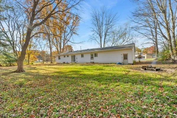 Back of house with a lawn